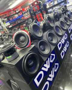 A row of speakers in the middle of a store.